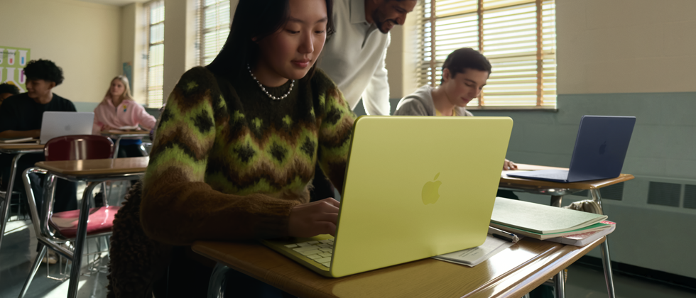 A student uses MacBook Neo, citrus colour, unplugged in a classroom setting